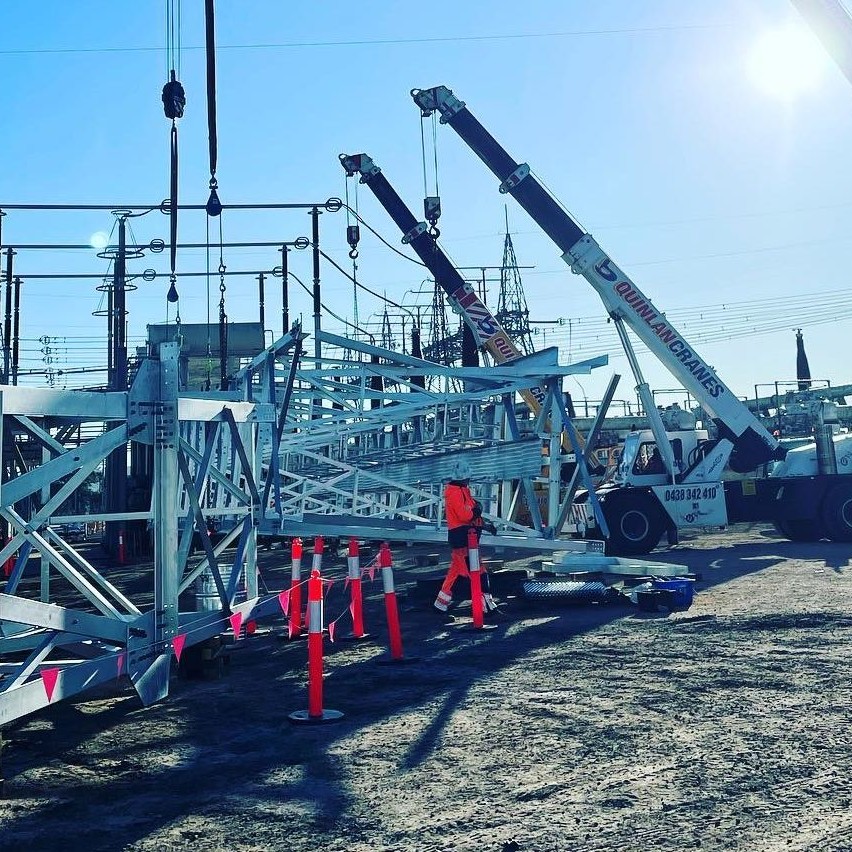 A Series Of Quinlan Cranes On A Large Scale Job Site