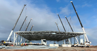 Series Of Cranes Outside Lifting Up Steel Roof